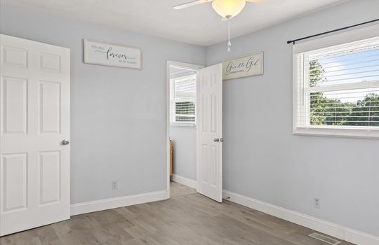 primary bedroom, window, ceiling fan, luxury vinyl flooring, primary bathroom
