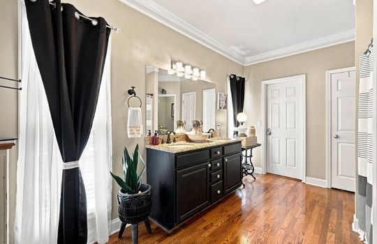 primary bathroom, windows, sink, double vanity sink, hardwood flooring, shower/tub, door to walk in closet, linen closet door