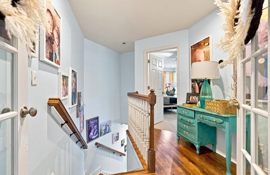 upper level landing, hardwood flooring, doorway to bedroom