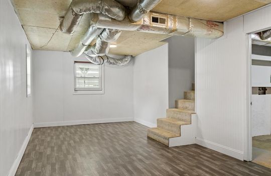 bonus room, stairs to main level, windows, luxury vinyl flooring, door to garage