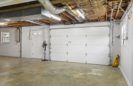 garage, garage door, exterior door, concrete flooring, window, block walls