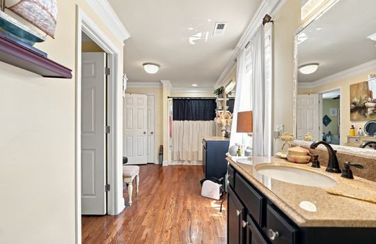 second bedroom ensuite, double sinks, shower/tub, hardwood flooring