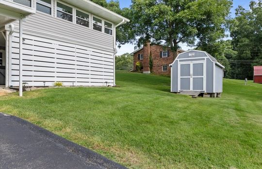back yard, storage shed, privacy walls covering patio space, sunroom, driveway