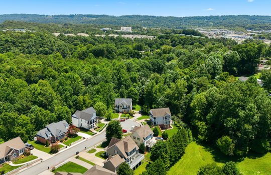 aerial view of home, front of home, sidewalk, driveway, concrete driveway, garage, 2 car garage, shingle roof, neighboring homes, mountains, end of cul-de-sac