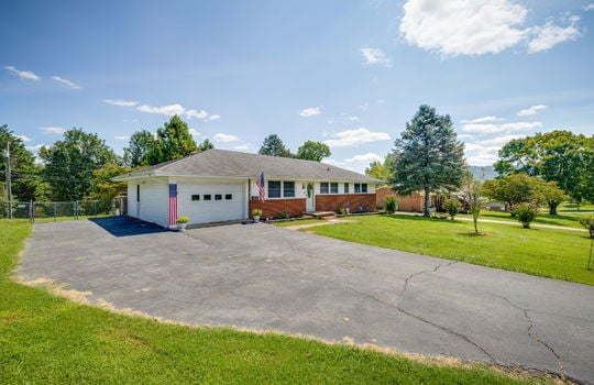 driveway, garage, garage door, ranch style home, brick, vinyl siding, sidewalk, front yard, landscaping, front door