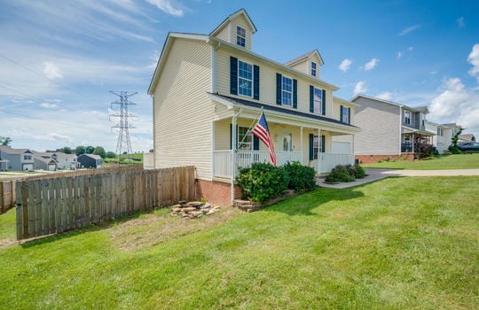 traditional style home for lease, front yard, sidewalk, landscaping, covered front porch, driveway, garage, fencing