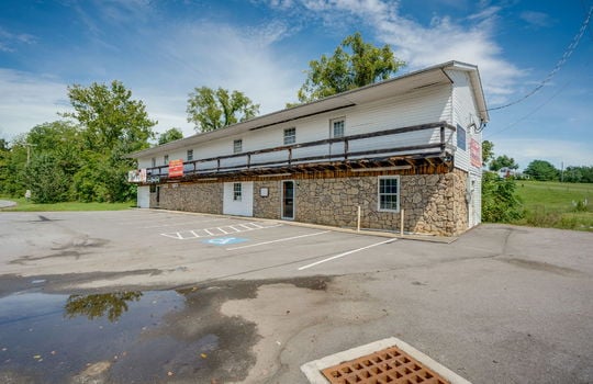 commercial space for lease, stone and vinyl siding exterior, glass door, parking lot, parking spaces