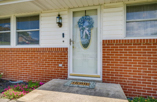 front door, front stoop, storm door, brick, vinyl siding