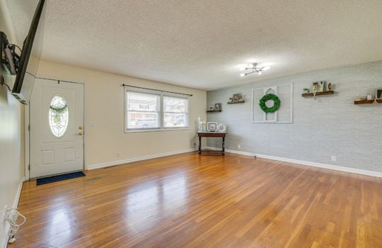 living room, front door, window, hardwood flooring