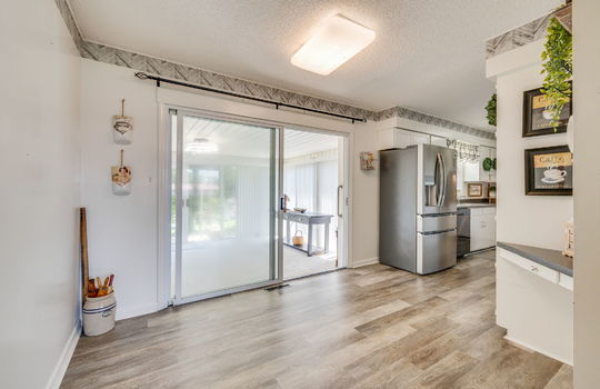 eat-in kitchen, luxury vinyl flooring, sliding glass door to heated sunroom, kitchen