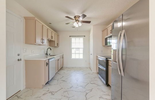 kitchen, stainless appliances, built in microwave, oven/range, refrigerator, dishwasher, sink, countertops, cabinets, window, ceiling fan