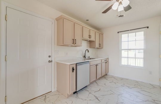 kitchen, dishwasher, sink, window, cabinets, countertops, ceiling fan, door