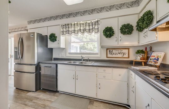 kitchen, refrigerator, dishwasher, sink, window above sink, cabinets, countertops, cooktop