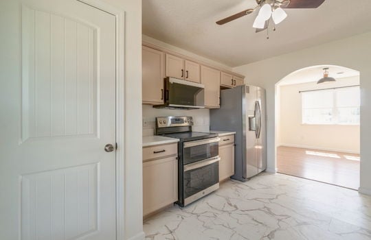 kitchen, ceiling fan, stainless appliances, refrigerator, built-in microwave, oven/range, cabinets, countertops, pantry/storage
