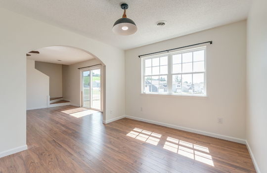 dining area, luxury vinyl flooring, windows, arched doorway,