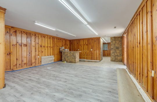 additional open area, wood paneling walls,