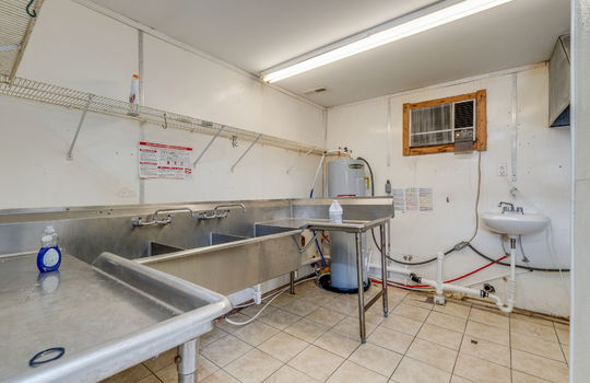 kitchen, dishwashing station, sinks, water heater, shelving, tile flooring
