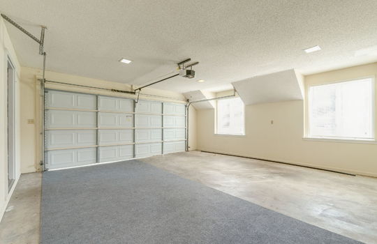 garage, concrete flooring, windows, garage door