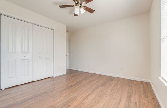 bedroom, luxury vinyl flooring, ceiling fan, closet, window