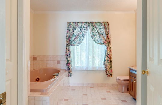 bathroom, tile flooring, tub, tile wall, toilet, sink