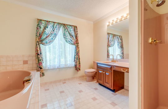 primary bathroom, tile flooring, tub, soilet, shower, sink