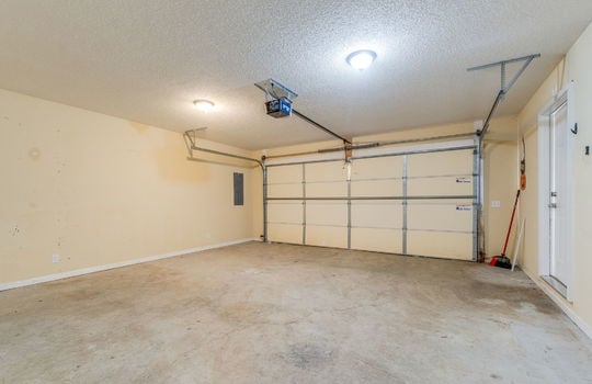 garage, 2 car garage concrete flooring, garage door, interior entry door