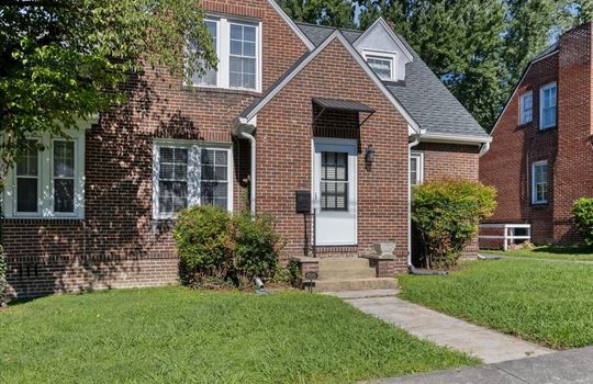 front view of home, sidewalk, stairs, front door, brick exterior, shingle roof, landscaping