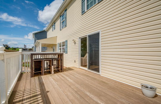 back deck, wood deck, railing, interior entry door, sliding glass door