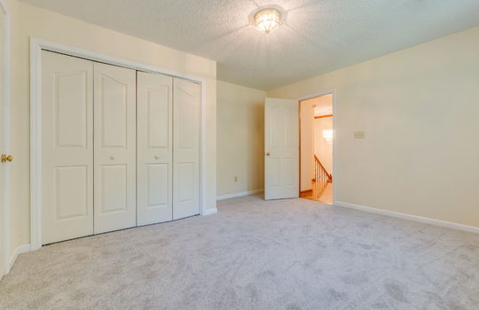bedroom, closet, carpet, doorway to upper level hall