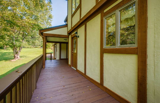 back deck, covered back deck, wood deck, railing, wood siding, tudor style home