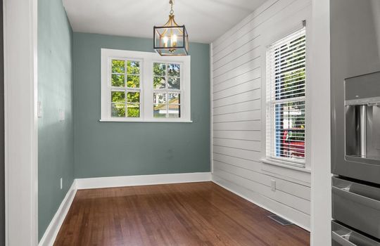 dining area, dining room, chandelier, windows, shiplap wall, hardwood flooring