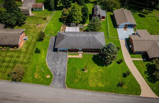 aerial view of home, road, driveway, front yard, back yard, shingle roof, fenced back yard, neighboring homes