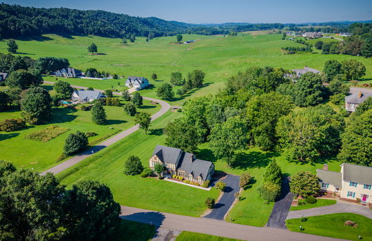 aerial view of home, neighborhood, neighboring homes,mountains, road