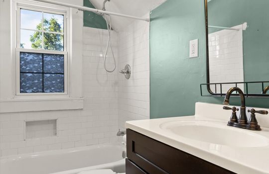 upper level bathroom, tile shower, tub, sink, toilet, window