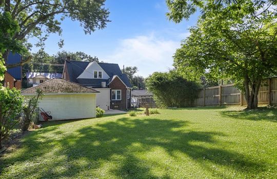back yard, trees, fencing, back of home, brick exterior, back patio, side porch