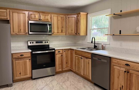 kitchen, cabinets, countertops, shelving, sink, window above sink, stainless steel appliances, dishwasher, refrigerator, oven/range, built-in microwave