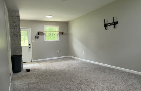 family room/den, carpet, exterior door, window, tv mount