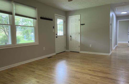 living room, windows, front door, closet, hallway, hardwood flooring