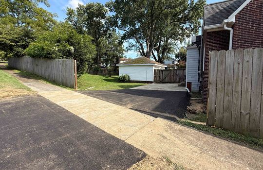 new asphalt driveway, back yard, fencing, back of home
