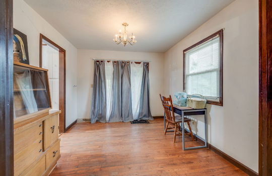 dining room, hardwood flooring, windows, chandelier, doorway to kitchen