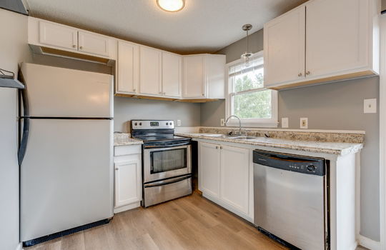 kitchen, refrigerator, oven/range, dishwasher, sink, countertops, cabinets, window above sink, vinyl flooring