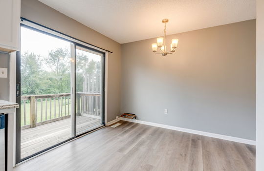 dining space, chandelier, sliding door to back balcony, vinyl flooring
