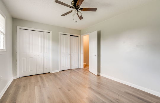 bedroom, closets, door, ceiling fan, vinyl flooring