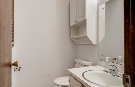 half bath in primary bedroom, sink, toilet