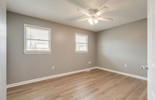 bedroom, ceiling fan, windows, vinyl flooring