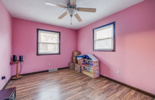 bedroom, hardwood flooring, wood trim, windows, ceiling fan
