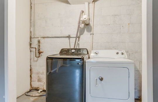 laundry space, concrete flooring, washer/dryer hookups,