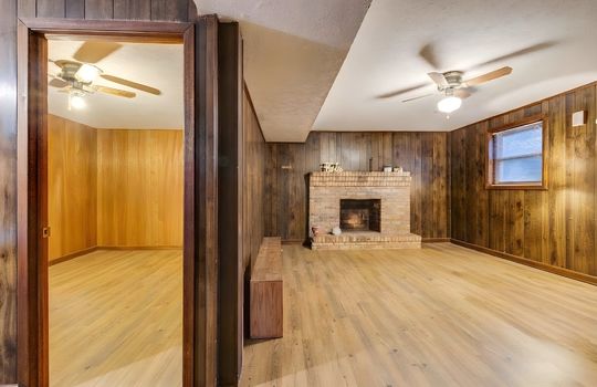 lower level den, lower level bedroom, fireplace, hardwood flooring