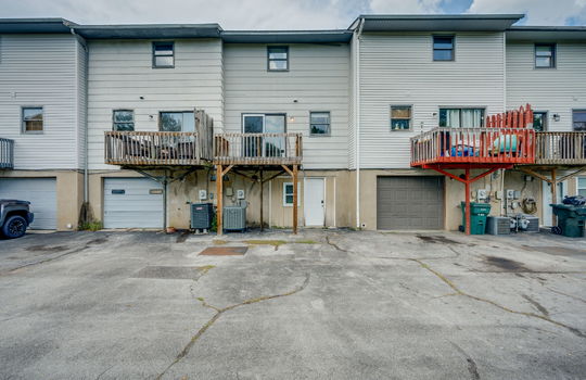 back of townhome, back balcony, windows, sliding door, heat pump