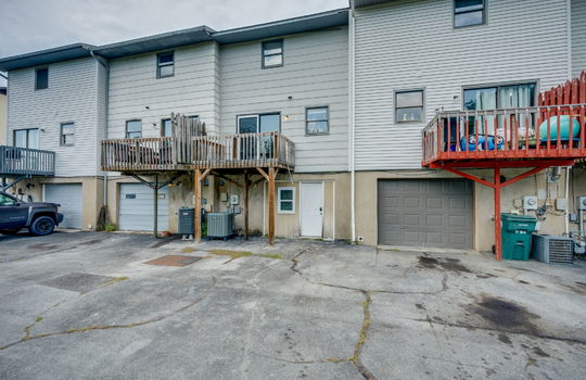 back of townhome, exterior entry door, back balcony, balcony door, neighboring townhomes